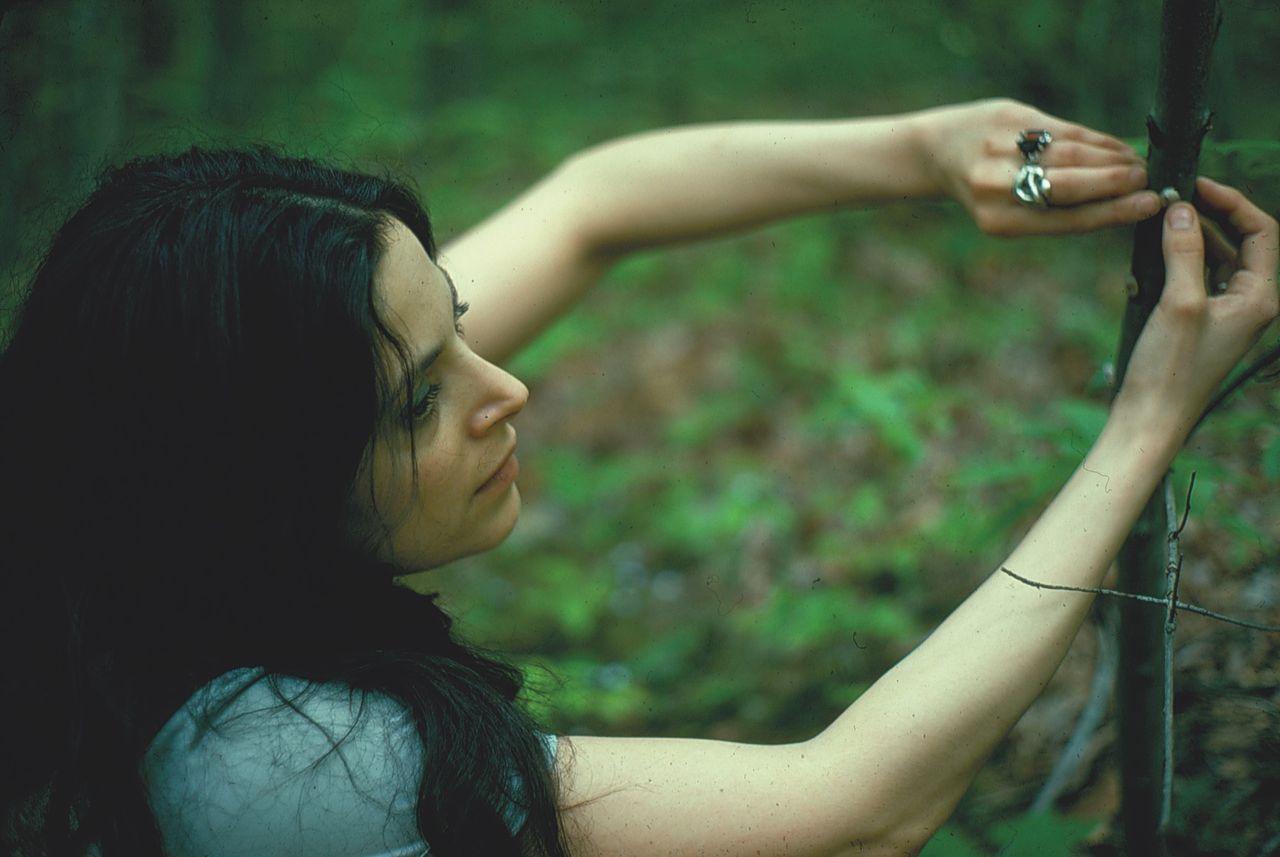 Hannah Wilke Placing Gum Sculpture on Tree in Landscape  1976 Hwcala C Scharlatt Vaga at Ars Gum Landscapes 106.jpg